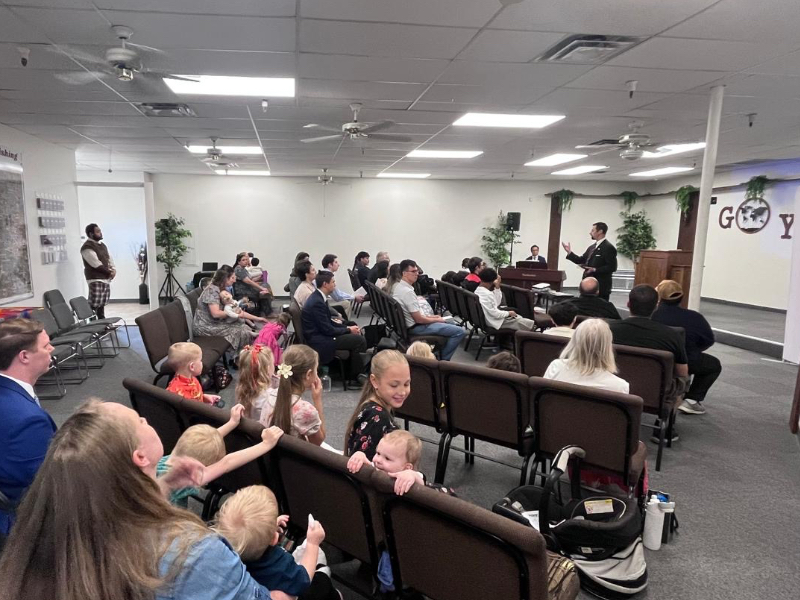 auditorium full of people sitting in chairs